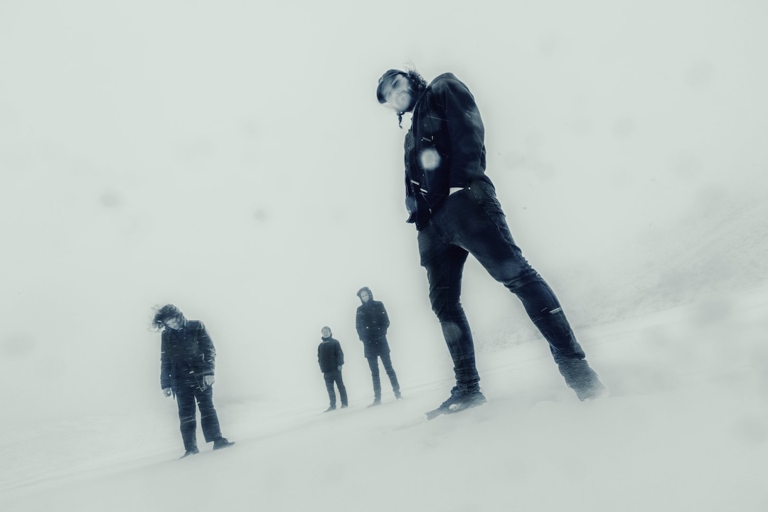 UNTITLED WITH DRUMS standing in a white, fog-blown winter landscape